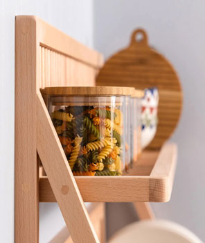 A close up of a plate storage rack taken side on, showing how the top shelf can be used to store jars full of dried foods