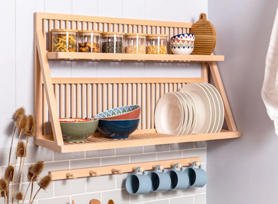 Wall mounted plate rack shelf being used to display plates, cups and other kitchen ware items. 