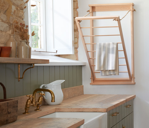 Wall mounted beadboard drying rack in situ within a utiling laundry room